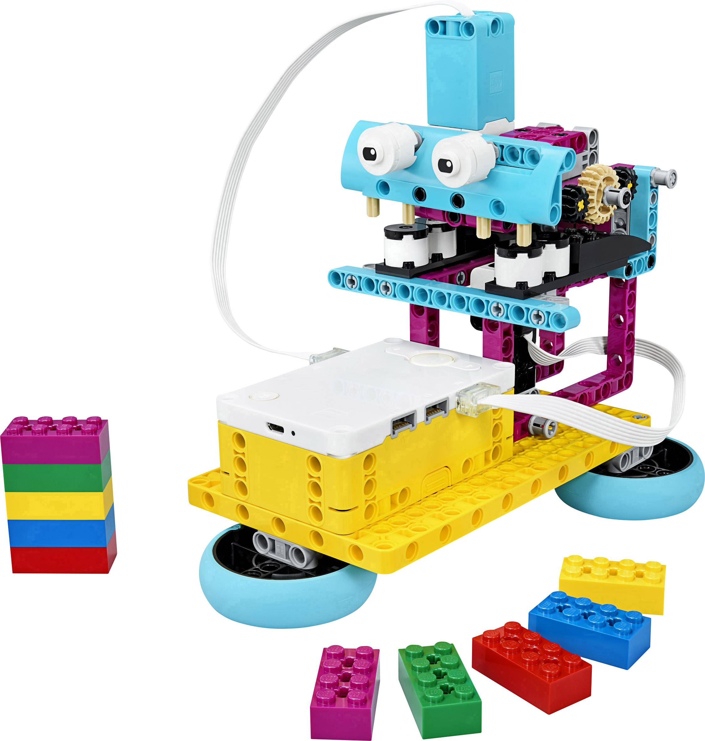 A colourful LEGO robot with two wheels and building blocks beside it, demonstrates a simple, child-friendly robot construction.