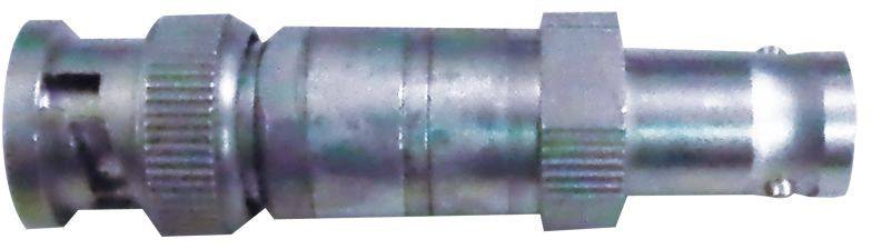 A silver metal adapter, presumably an HF coaxial plug with a knurled edge and cylindrical housing, is lying horizontally.