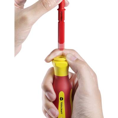 A hand is holding a red and yellow screwdriver, while another hand is inserting a red attachment.