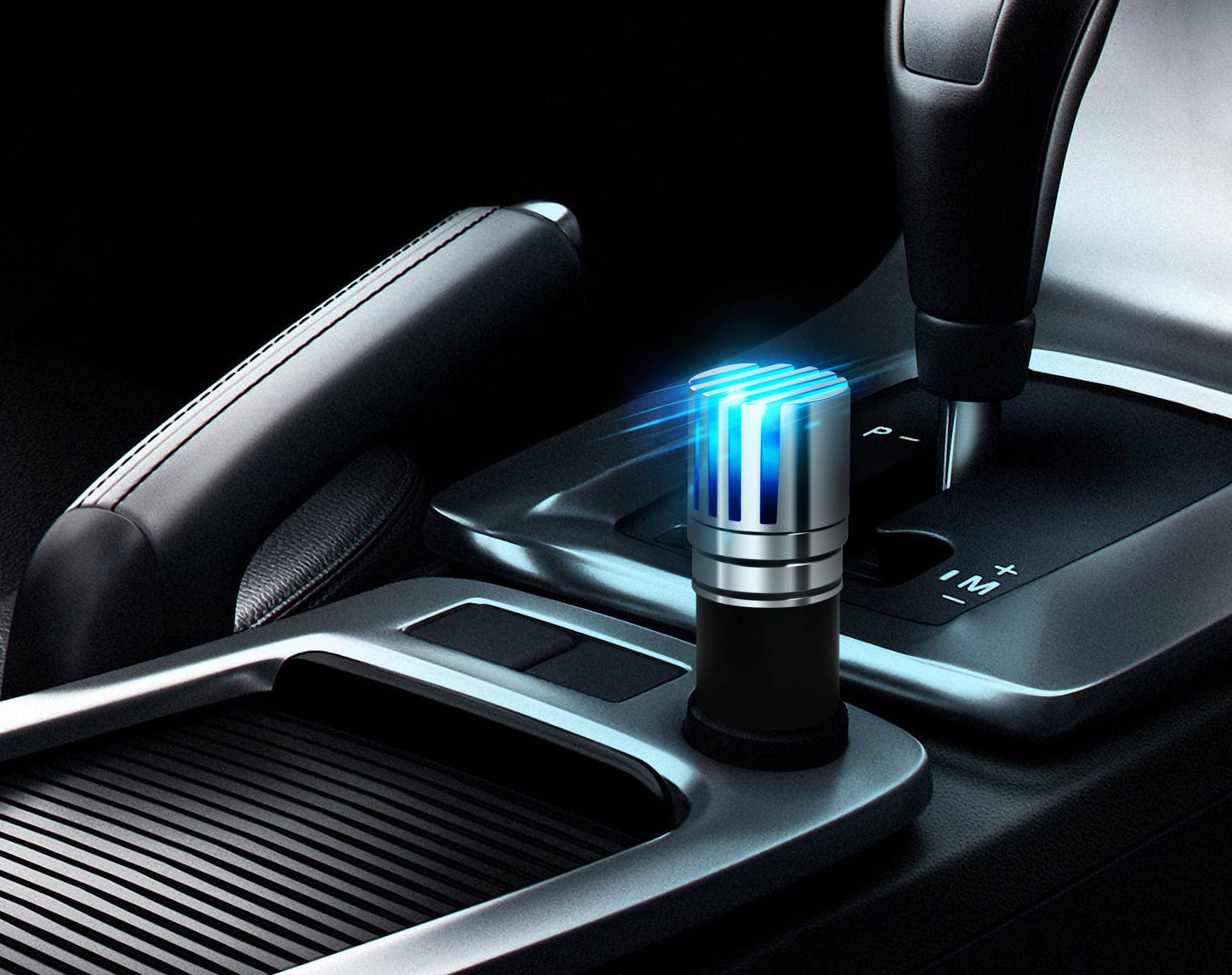 An air purifier sits in the centre console of a car, illuminated in blue light, next to the gear stick.