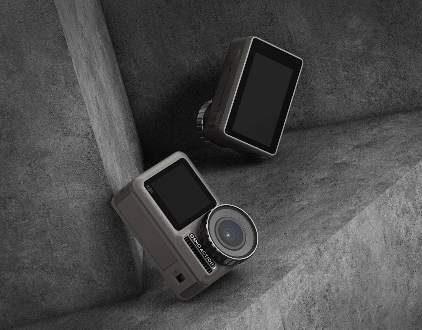 Two action cameras on concrete surfaces. One camera showing the lens, the other the screen. Grey, minimalist environment.