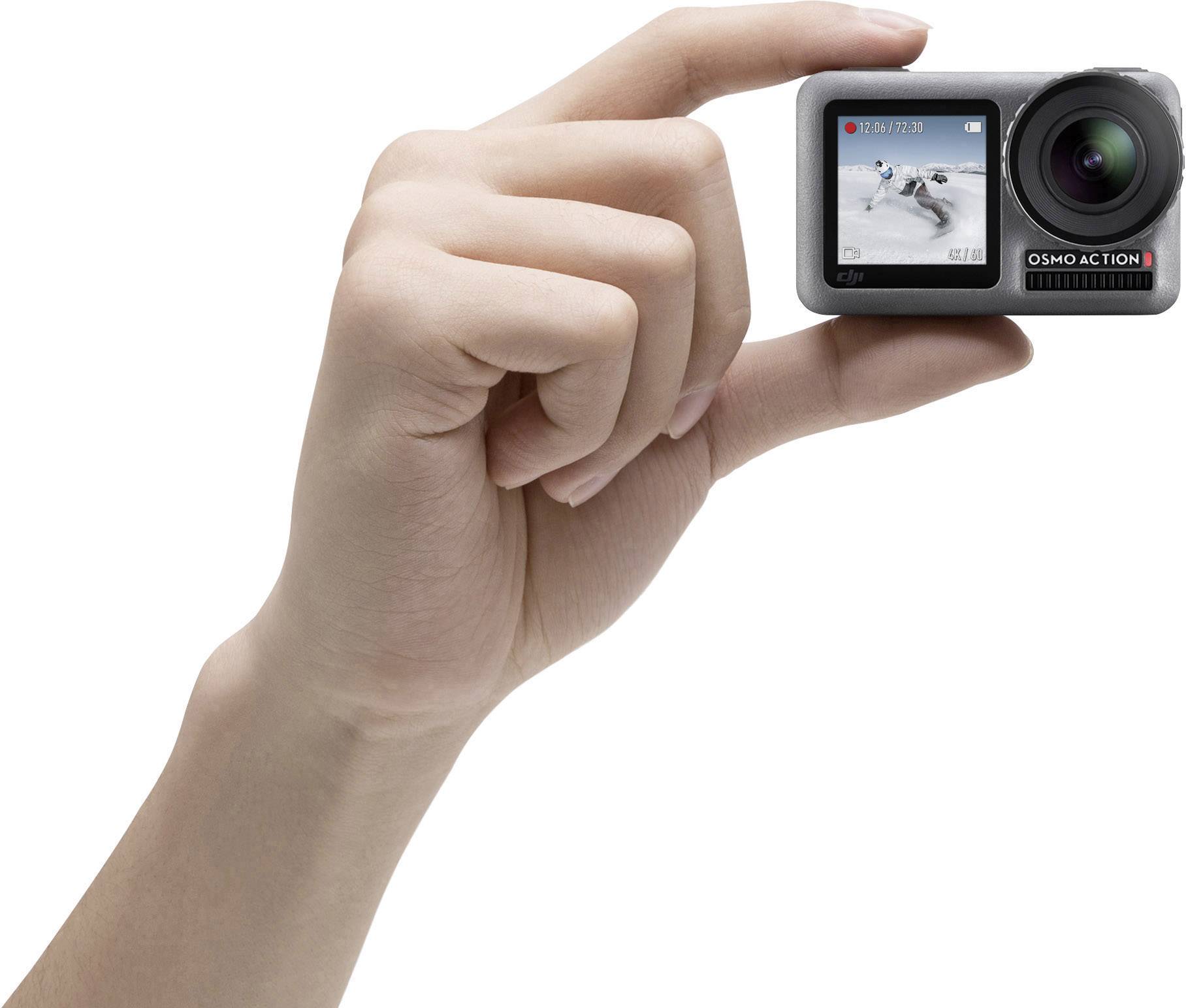 A hand is holding a small action camera, with a scene of a snowboarder displayed on its screen.
