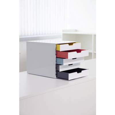 Small drawer cabinet with four coloured drawers (yellow, red, blue, black) sits on a white table in an office.