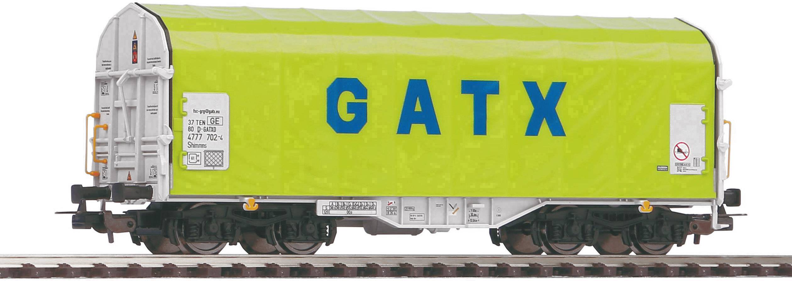 'Railway goods wagon with a green protective roof and blue lettering "GATX" on the side.'
