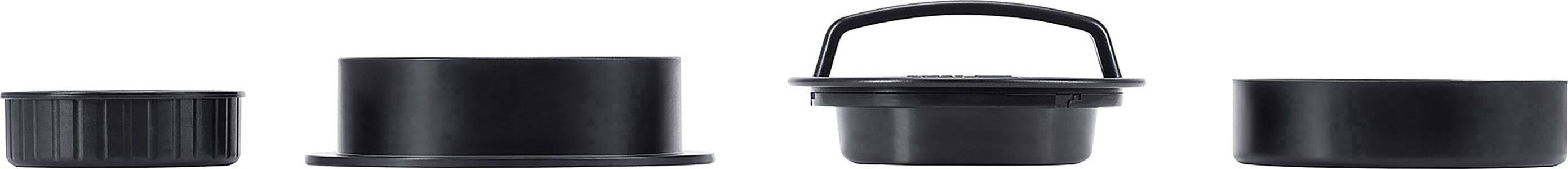 Four black plastic lids in various shapes and sizes, arranged side by side.