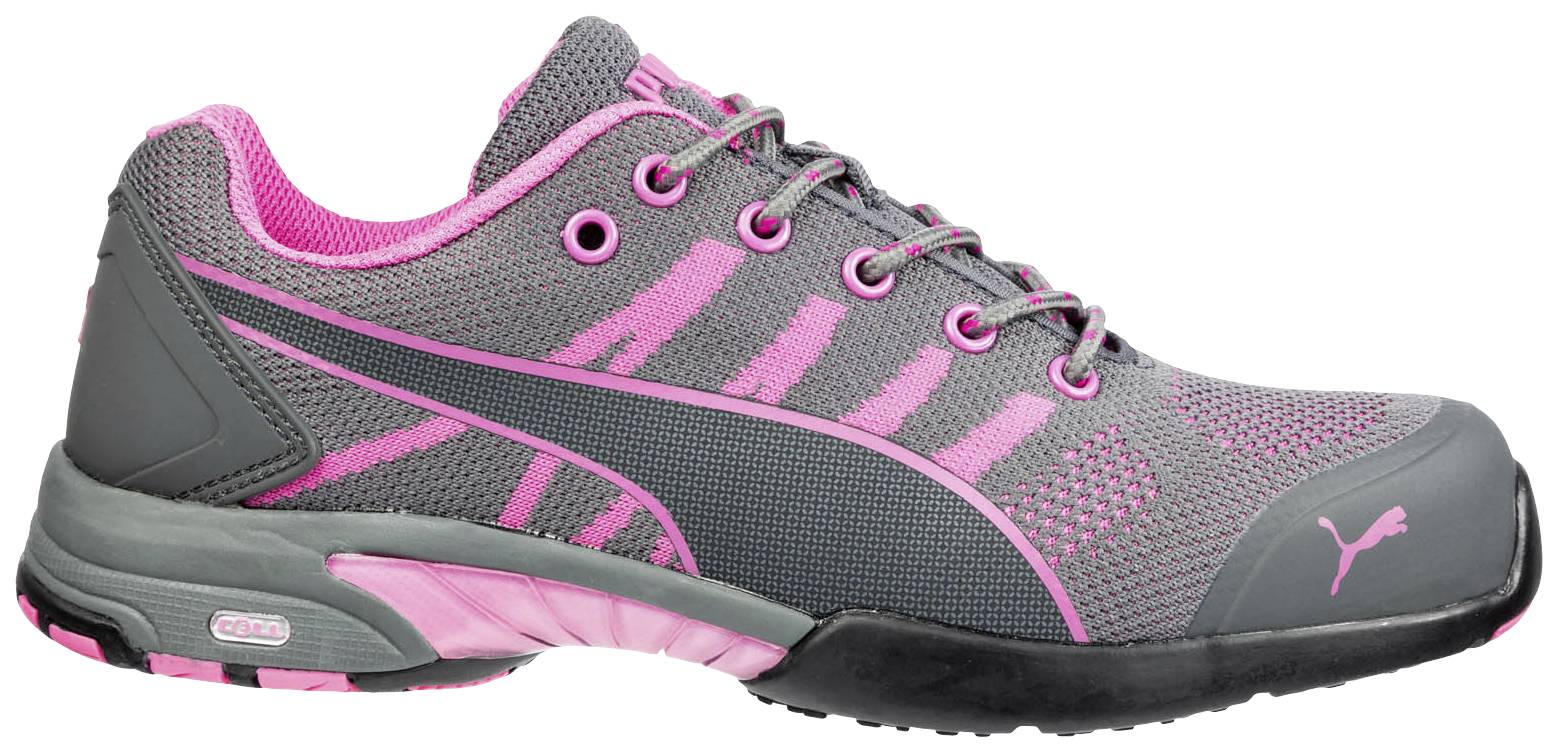 Grey trainer with pink accents, light sole tread, and laces, with a stylised logo on the side.