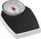 An analogue personal weighing scale with a black base area and a circular dial, displaying weight in kilograms.