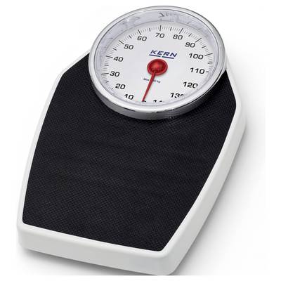 An analogue weighing scale with a red pointer indicating approximately 70 kilograms. The scale has a black standing surface and a white casing.