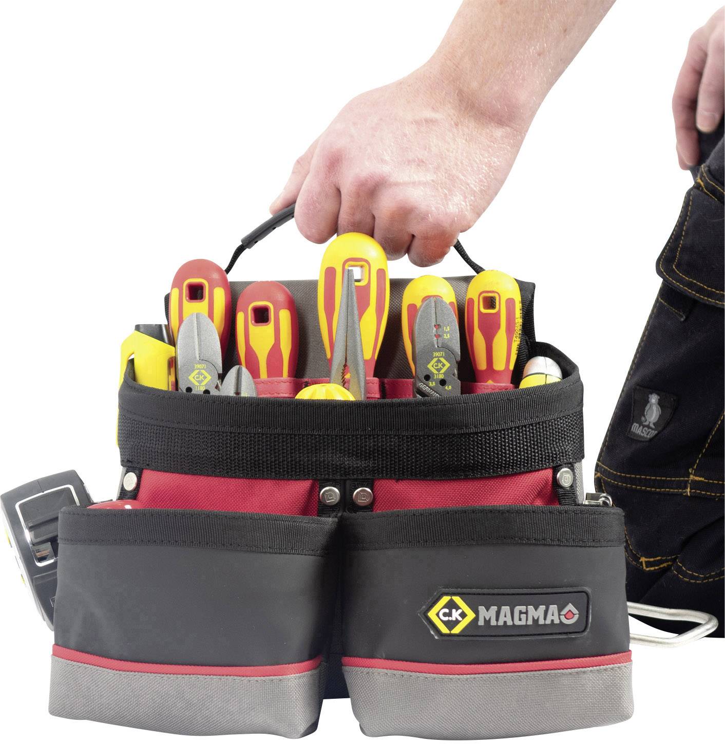 'A hand is holding a red tool bag with various screwdrivers and pliers. The bag has multiple compartments.'
