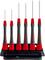 Six precision screwdrivers with red and black handles are standing in a black holder.