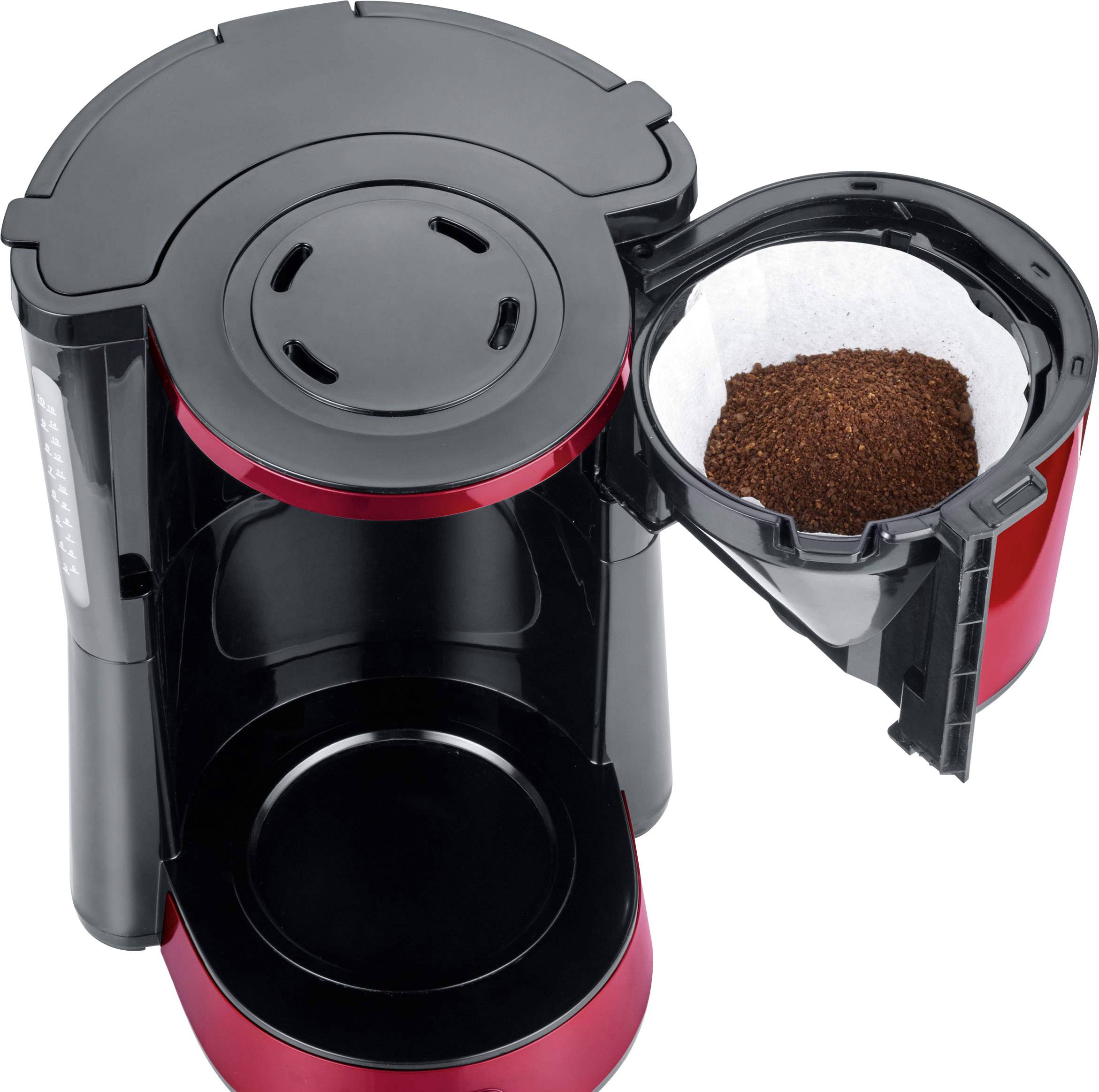 Coffee machine with open filter compartment, filled with coffee grounds. Main colours are red and black. Ready to brew.