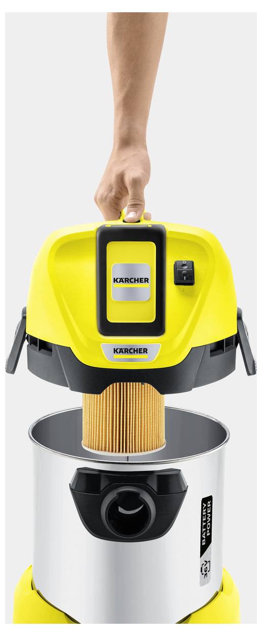 A person lifts the top of a yellow vacuum cleaner, revealing a filter inside the stainless steel canister, demonstrating maintenance.