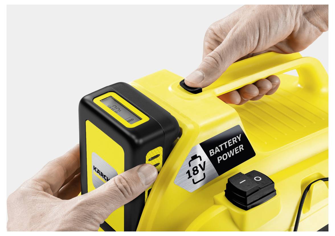 'Hands inserting an 18V battery into a yellow device labeled 'BATTERY POWER'.'