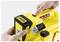 'Hands inserting an 18V battery into a yellow device labeled 'BATTERY POWER'.'