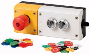 An emergency stop switch with two silver buttons, surrounded by colourful chips that could serve as control or gaming markers.