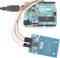 Arduino board connected with cables to an RFID reader. Shows the connection for an electronics project.