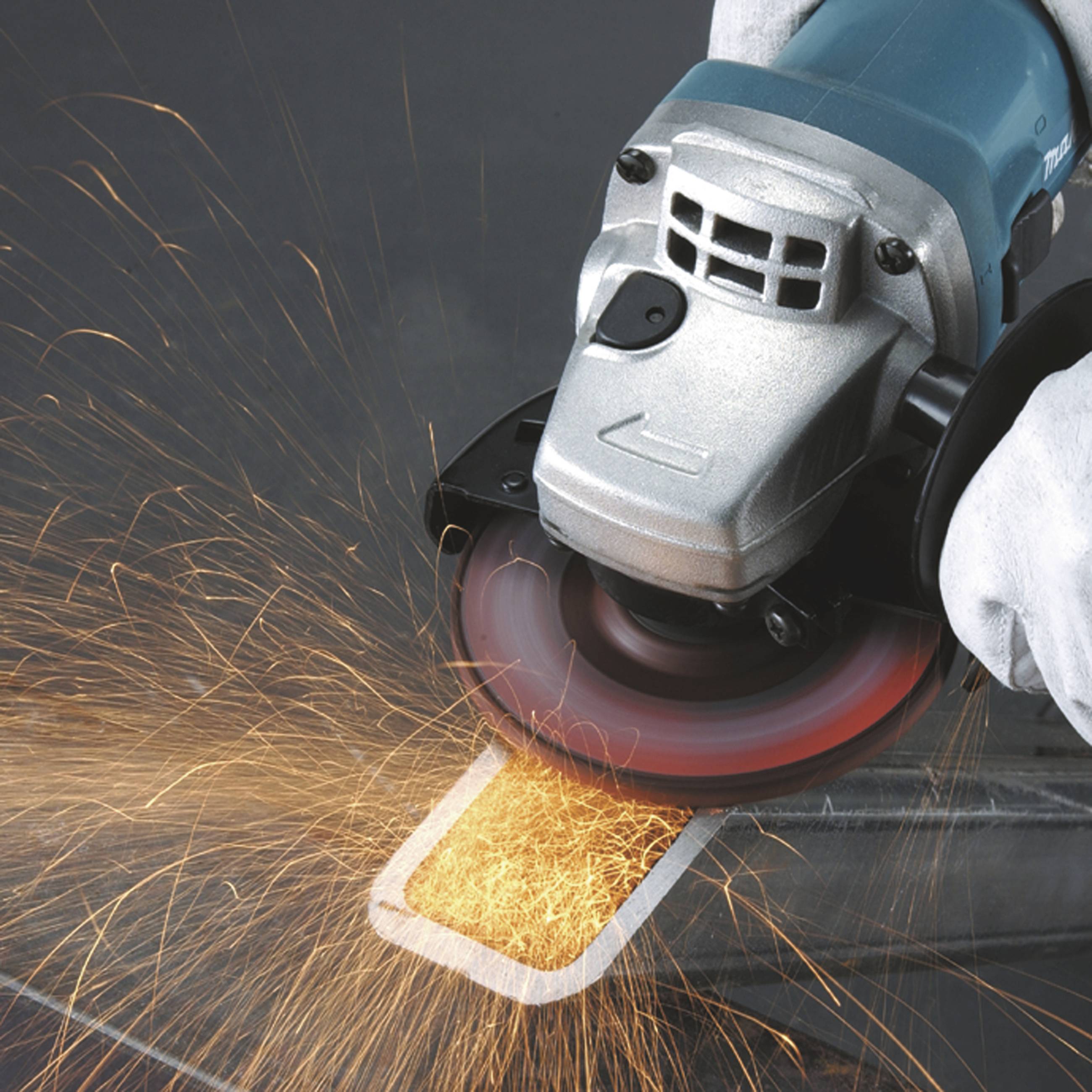 A hand holds an angle grinder, generating sparks while grinding metal.