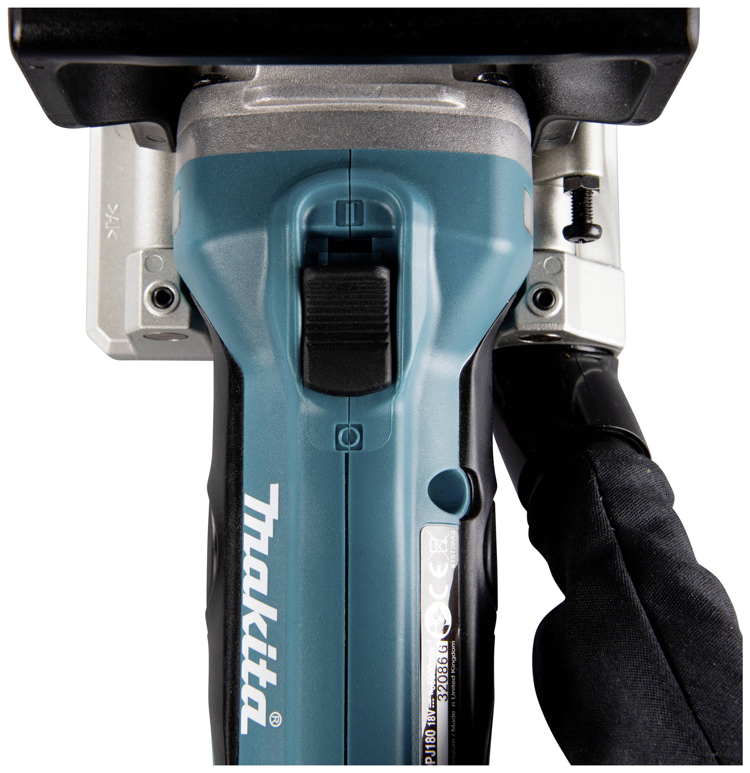 A cordless power tool in close-up, with a gloved hand gripping the handle.