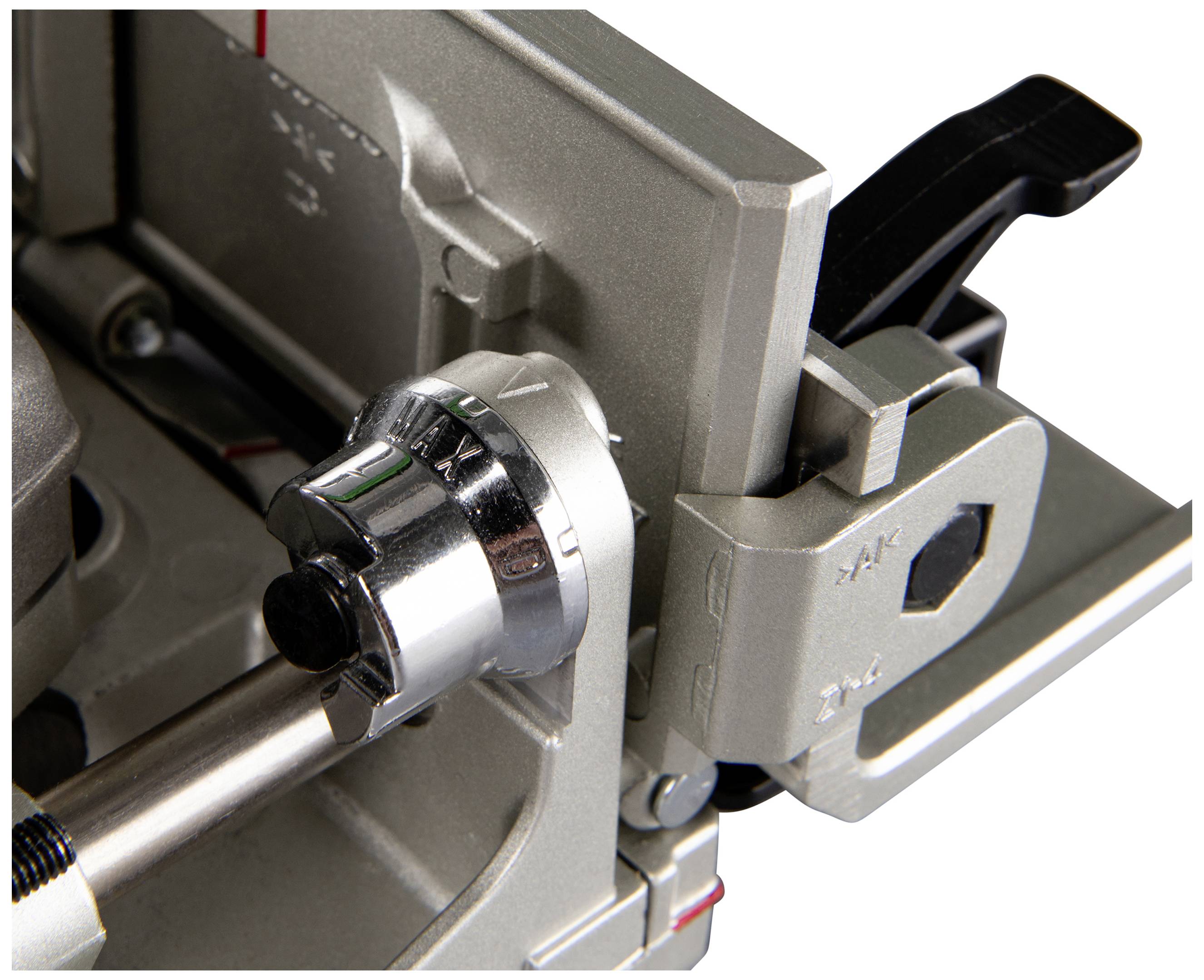 Close-up of a silver metal mechanism with a lever and ratchet system, likely part of a tool or machine component.