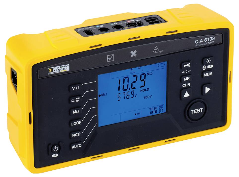 A yellow electrical testing device with a black display shows '10.29 MΩ' and '576.9 V'. Buttons for various measurement modes are visible.