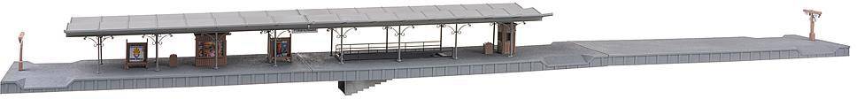 'Model railway platform with waiting shelter and canopy, grey platform, subtle details.'