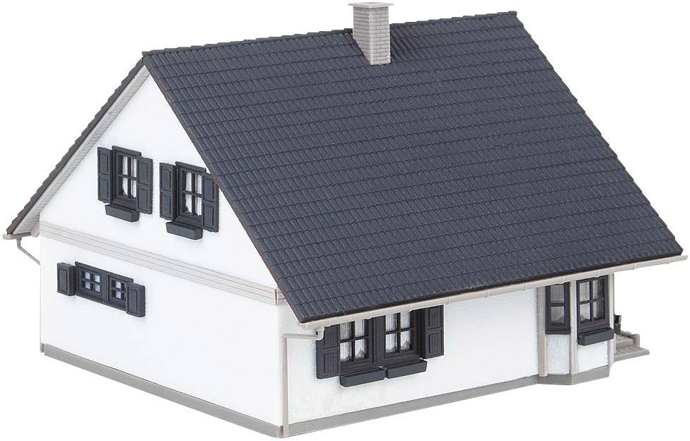 A white two-storey house with a black roof, black shutters, and a chimney.