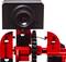 A black camera is mounted on a red, technical structure containing gears and mechanical parts.