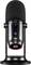 Black studio microphone on stand with various controls and an LED indicator for recording levels. Perfect for audio recordings.