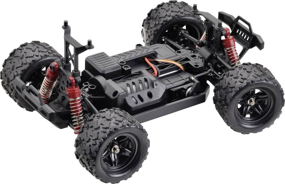 A remote-controlled toy car without bodywork, revealing its internal hardware, large treaded tyres, and red shock absorbers.