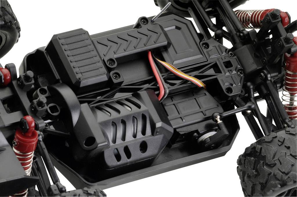 Close-up of a remote-controlled vehicle chassis with visible wiring, battery, and suspension components.