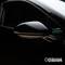 Car wing mirror in black, in focus. The surroundings are dark, which highlights the mirror. The brand name 'Osram' is visible.