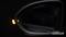 Side view of a car wing mirror with an illuminated warning signal against a dark background. The OSRAM logo is located in the bottom right of the image.