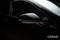 Side mirror of a black car, focus on the glossy surface and sleek form. 'OSRAM' brand logo positioned bottom right in the image.