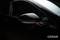 A black car with focus on the wing mirror, which gleams and is illuminated in a dark environment. 'OSRAM' is positioned bottom right.