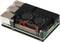 A single-board computer with a black heatsink and two fans on the top, several ports visible on the side.
