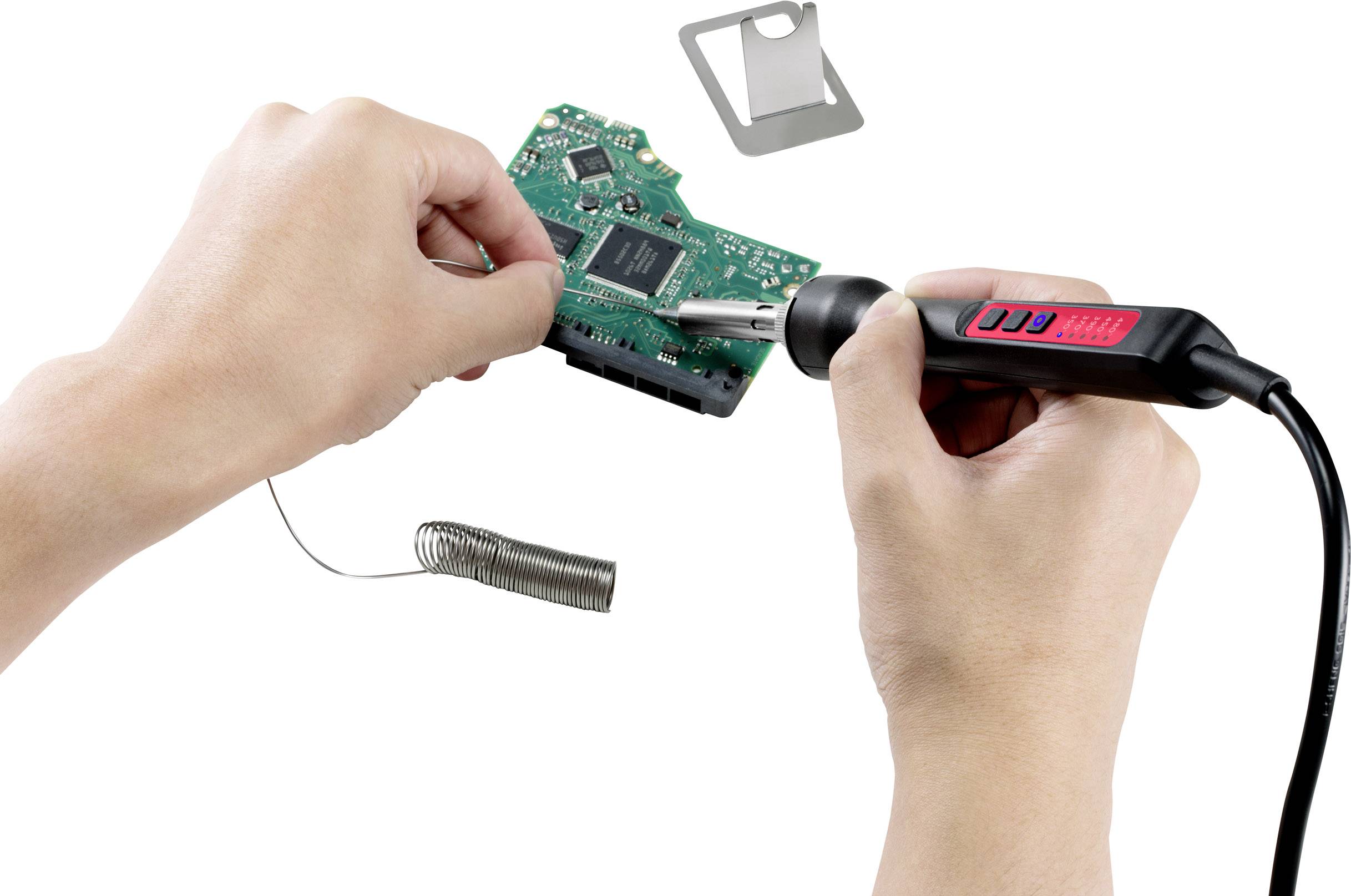 'Someone is soldering on a green circuit board using a soldering iron and solder wire.'