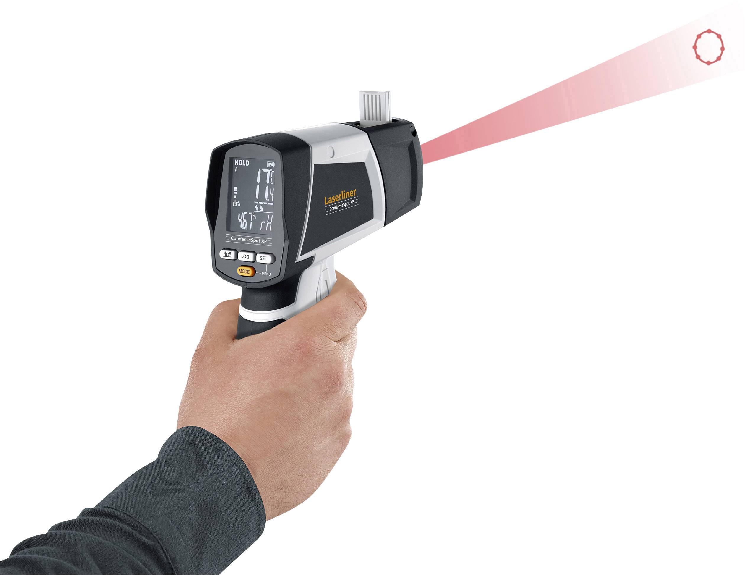A handheld temperature measurement device points at a target point. Display showing temperature data. A person holding the device with one hand.