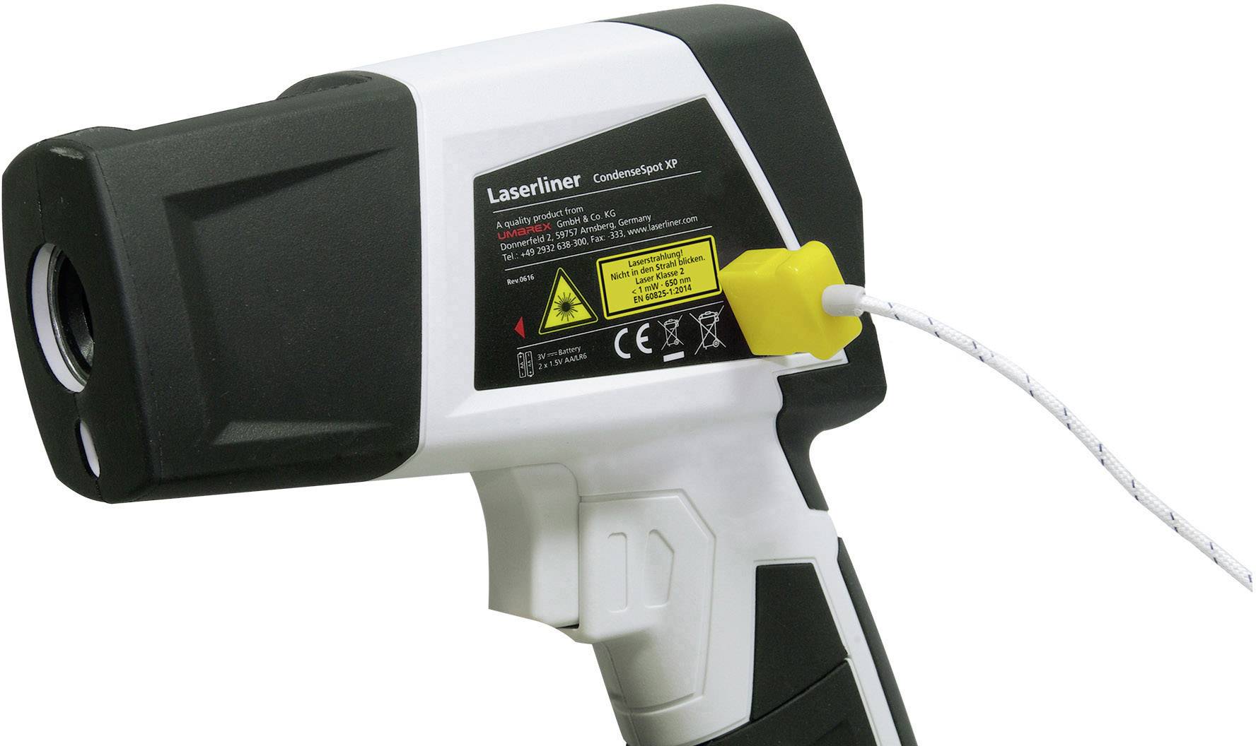 An infrared thermometer with a black and white surface. It is connected with a yellow cable and has warning labels printed on it.