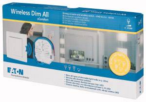 A person is pointing to a wireless dimmer switch in packaging with an image of a living room. An 'Eaton' product details marking is visible on the box.