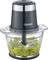 Electric blender with a black casing, transparent container, and green mixture of herbs and nuts inside.