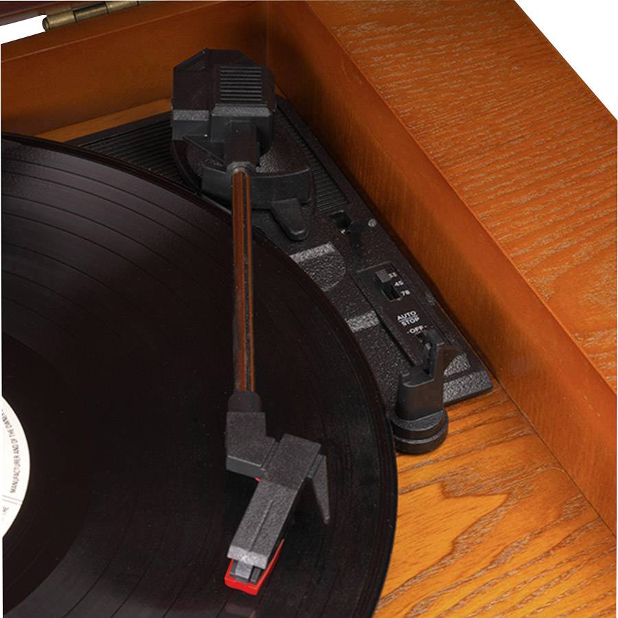 A wooden record player is spinning a black vinyl record. The tonearm is positioned to play music.