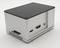 A rectangular, grey electronic device with ports on the side. Possibly a mini-computer or adapter.