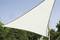 A large, white sun sail is stretched between trees, providing shade and protection from the sun in a natural setting.