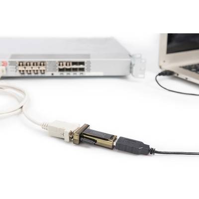 A laptop is connected via a USB cable to a network device that has multiple Ethernet ports.