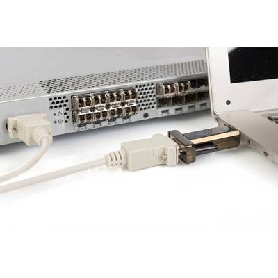 A laptop is connected to a network switch via a VGA adapter, enabling a wired connection.