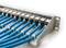 A patch panel with multiple connected blue network cables in a server environment.