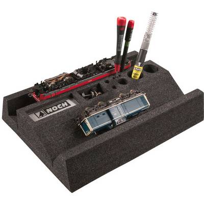 Model railway tool set on a black foam block with two small train models, tools, and a NOCH brand label.