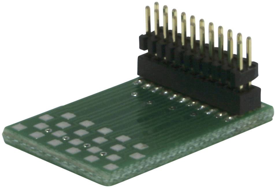 A green printed circuit board with several golden pins protruding vertically from a black connector strip.