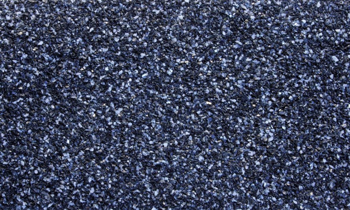 Close-up of a dark, grainy asphalt surface with blue and grey elements.