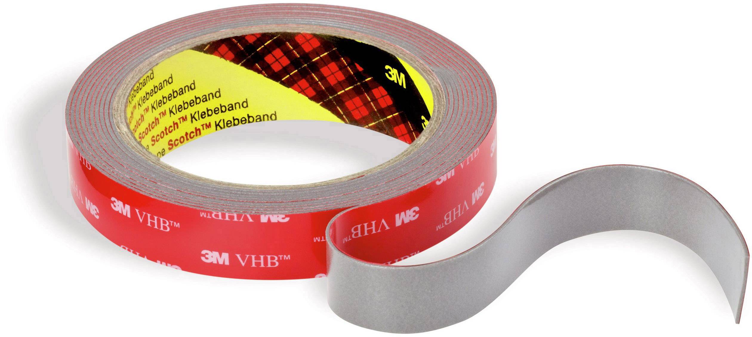 Role of a red double-sided 3M VHB adhesive tape, slightly unrolled, with adhesive and non-adhesive sides visible.